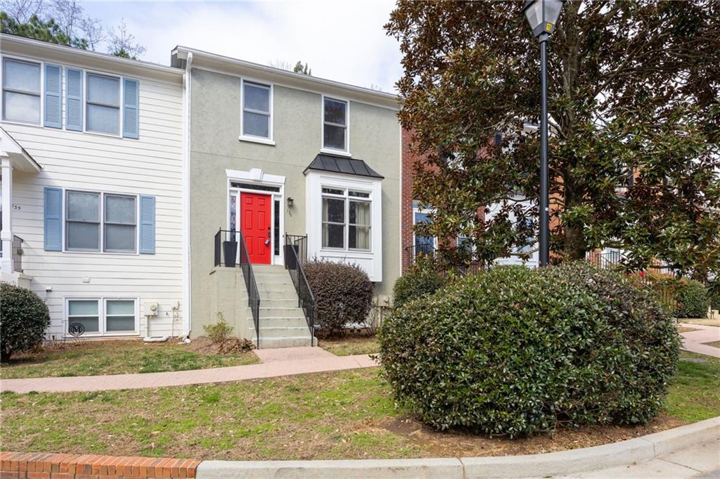 260 Manning Road Southwest, Unit 136 Marietta, GA 30064 - Photo 1 of 43 a front view of a house with garden