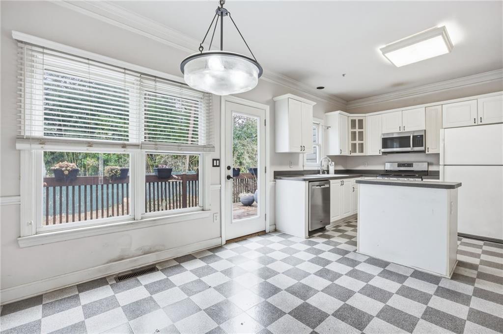 260 Manning Road Southwest, Unit 136 Marietta, GA 30064 - Photo 13 of 43 a kitchen with stainless steel appliances a stove a refrigerator and cabinets