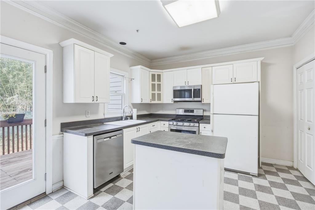 260 Manning Road Southwest, Unit 136 Marietta, GA 30064 - Photo 14 of 43 a kitchen with stainless steel appliances granite countertop a refrigerator sink stove and white cabinets