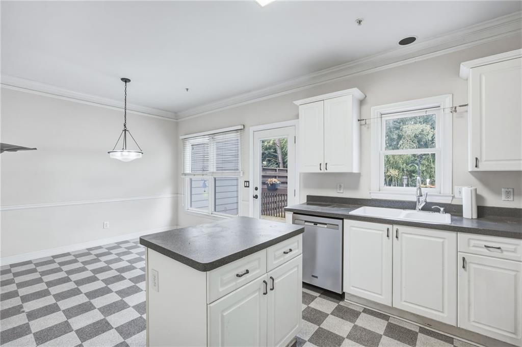 260 Manning Road Southwest, Unit 136 Marietta, GA 30064 - Photo 17 of 43 a kitchen with a sink a stove a window and cabinets