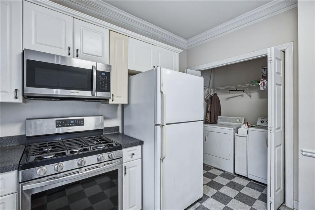 260 Manning Road Southwest, Unit 136 Marietta, GA 30064 - Photo 18 of 43 a white refrigerator freezer and a stove sitting inside of a kitchen