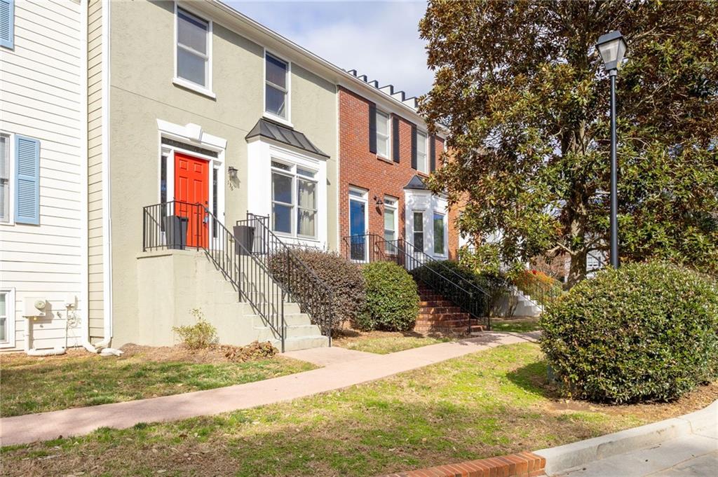 260 Manning Road Southwest, Unit 136 Marietta, GA 30064 - Photo 2 of 43 a front view of a house with a yard and garage
