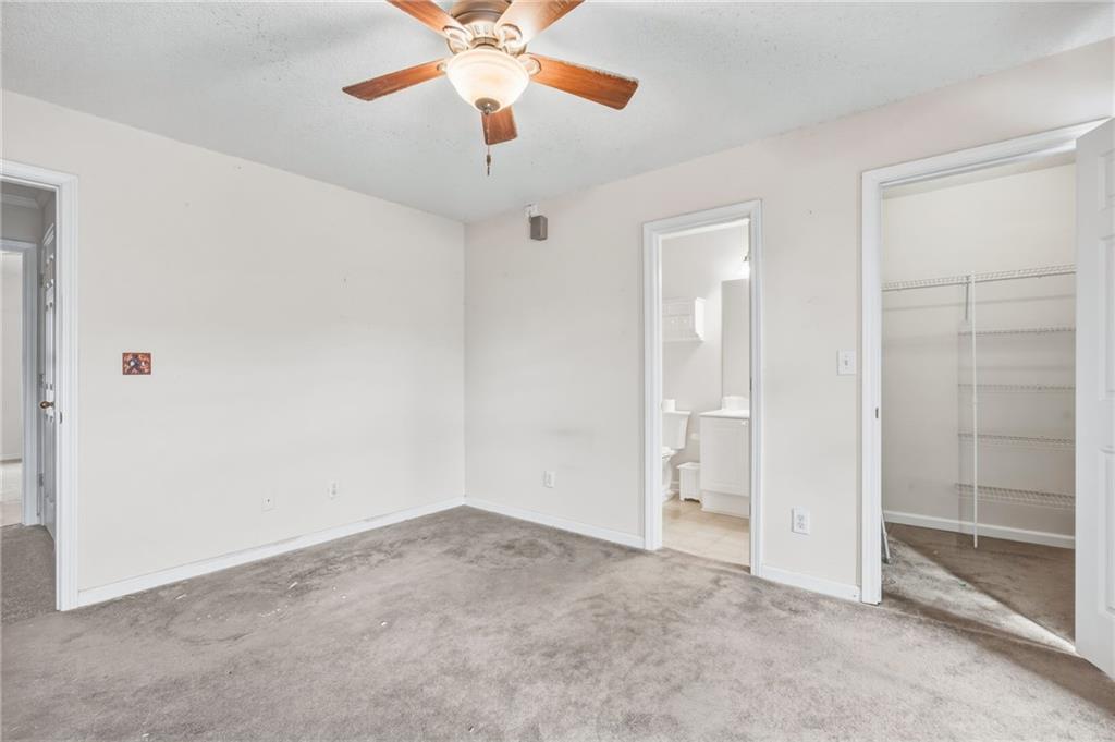 260 Manning Road Southwest, Unit 136 Marietta, GA 30064 - Photo 22 of 43 an empty room with closet and a chandelier fan
