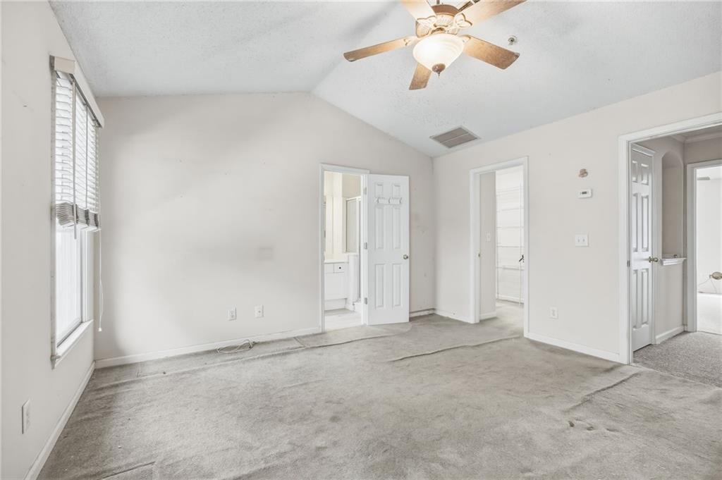 260 Manning Road Southwest, Unit 136 Marietta, GA 30064 - Photo 25 of 43 an empty room with chandelier fan and windows