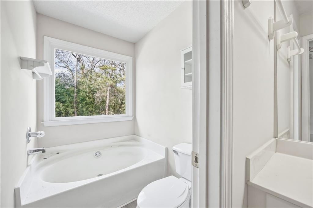 260 Manning Road Southwest, Unit 136 Marietta, GA 30064 - Photo 27 of 43 a white bath tub sitting next to a white toilet