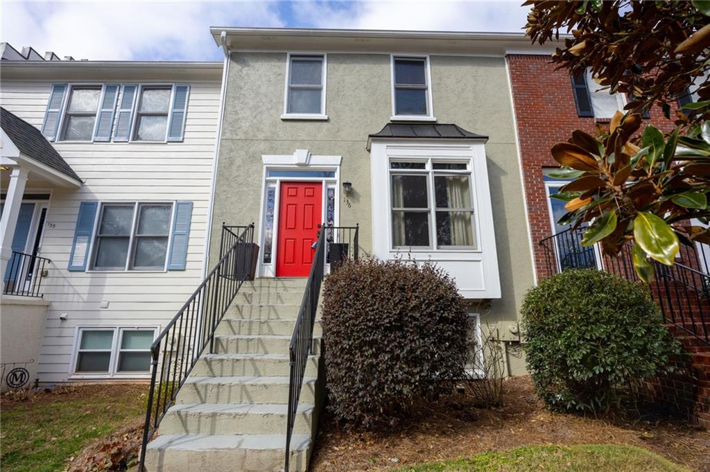 260 Manning Road Southwest, Unit 136 Marietta, GA 30064 - Photo 4 of 43 a front view of a house with a yard