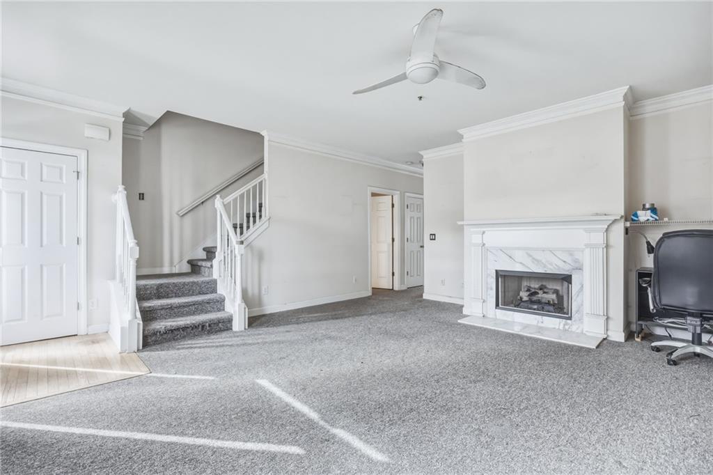 260 Manning Road Southwest, Unit 136 Marietta, GA 30064 - Photo 9 of 43 a view of a livingroom with a fireplace stairs and windows
