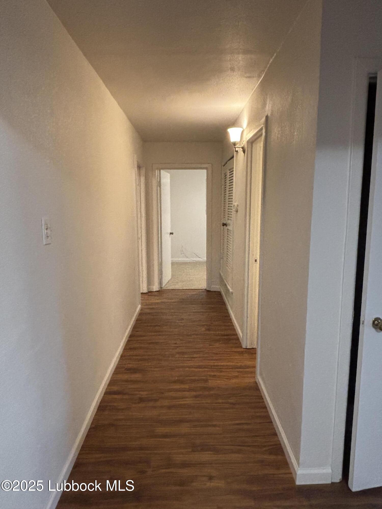 1301 6th Street Shallowater, TX 79363 - Photo 5 of 15 a view of hallway with wooden floor