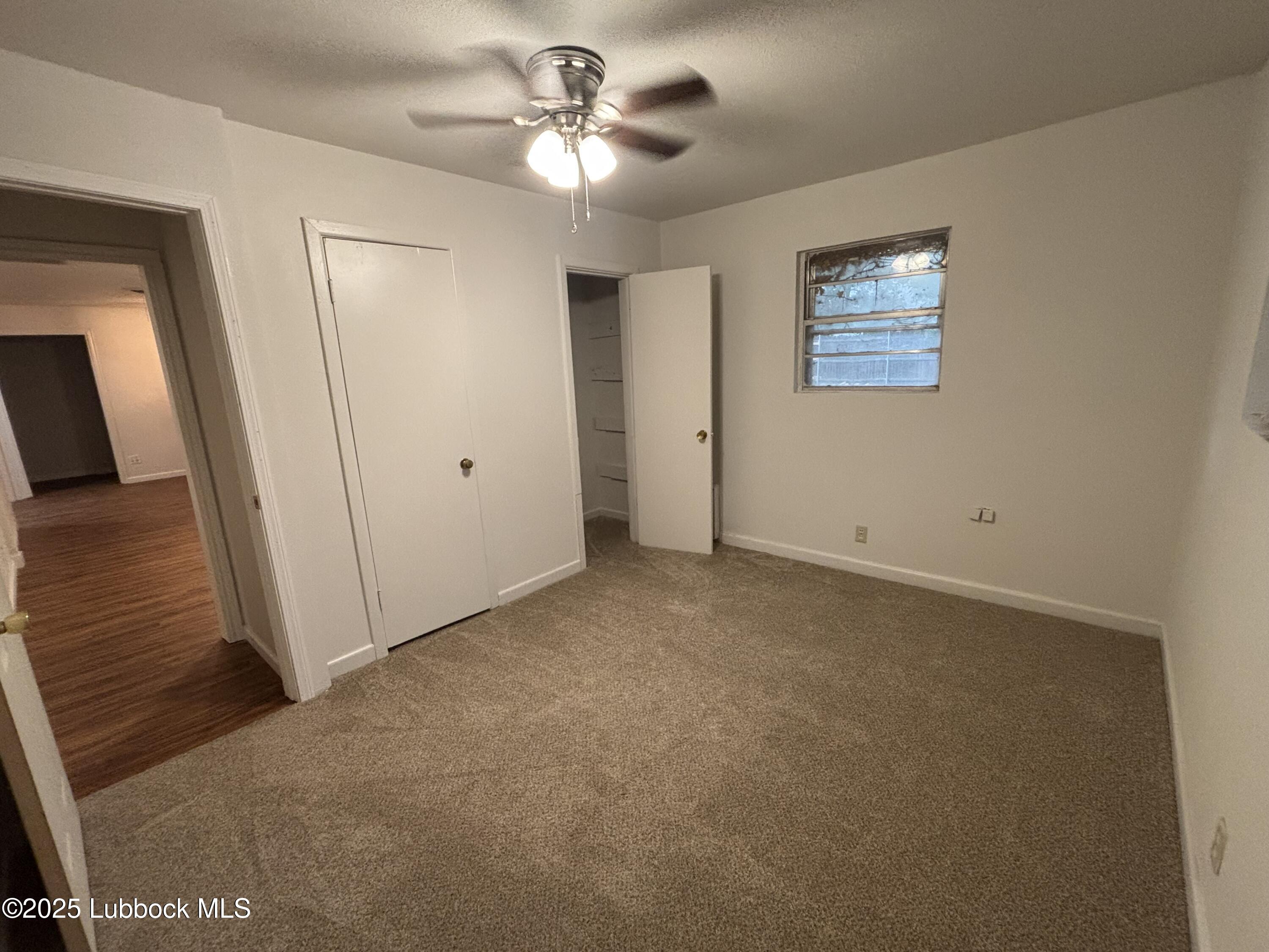 1301 6th Street Shallowater, TX 79363 - Photo 9 of 15 an empty room with windows and fan