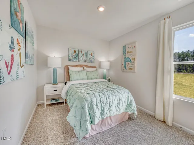 a bedroom with a bed and a lamp