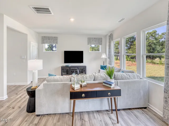 a bedroom with a bed and dresser next to a window