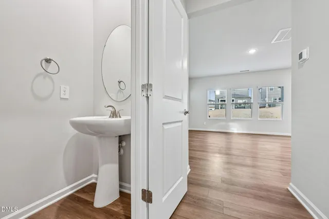 a bathroom with a sink mirror and tub