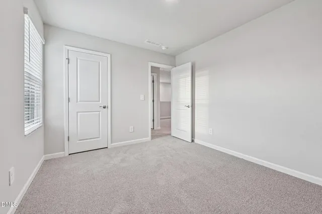 a view of an empty room and closet area