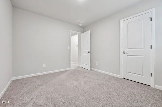 a view of an empty room and closet area