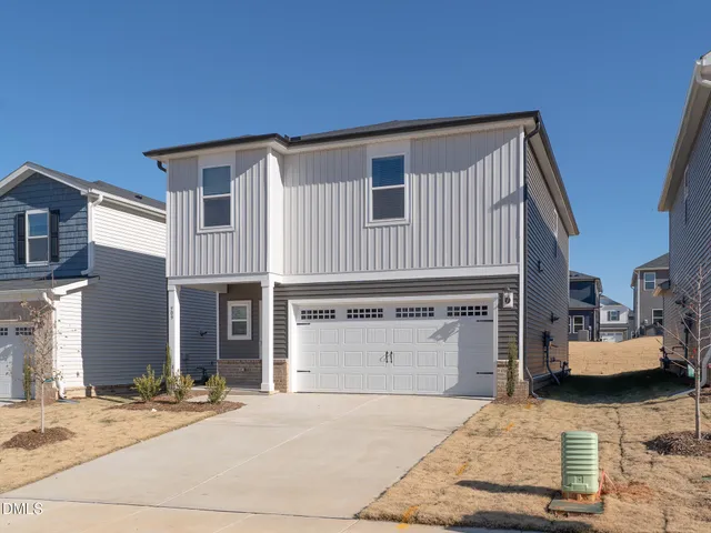 a front view of a house with a garage