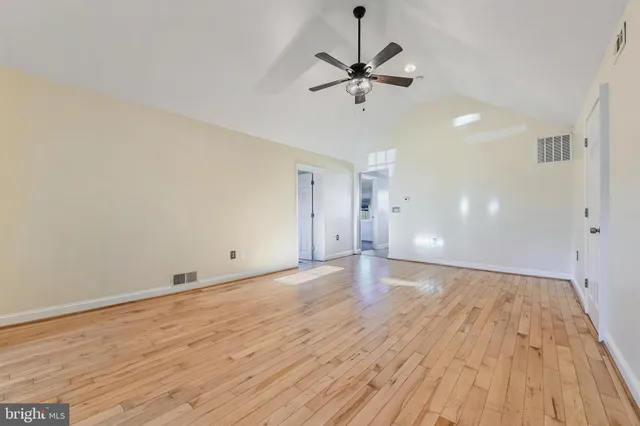 a view of an empty room and wooden floor