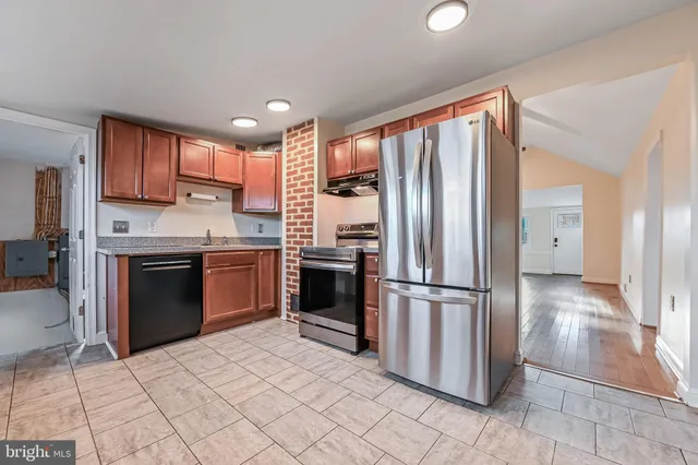 a kitchen with stainless steel appliances granite countertop a refrigerator sink and cabinets