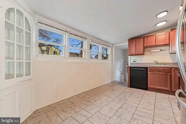 a kitchen with a stove a sink and a refrigerator