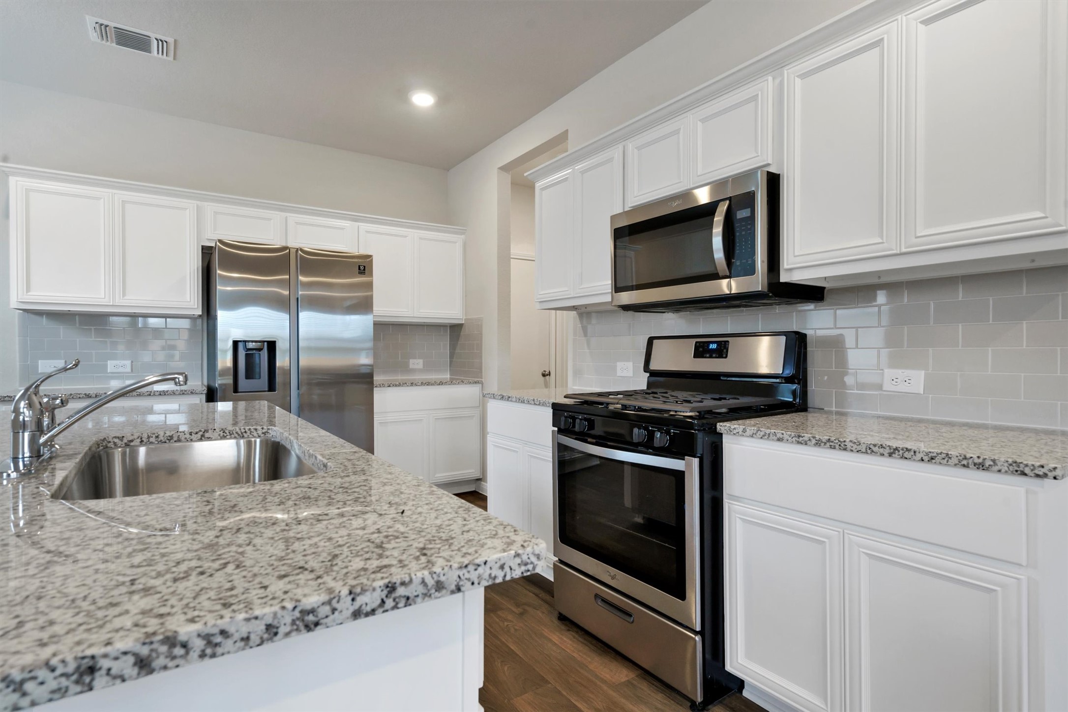 2909 Tweedy Trail Pflugerville, TX 78660 - Photo 14 of 27 A well-appointed kitchen showcasing elegant granite countertops and modern stainless steel appliances.