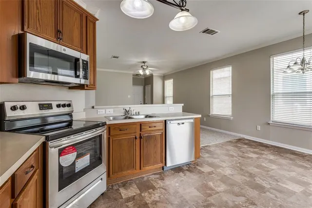a kitchen with a stove microwave and sink