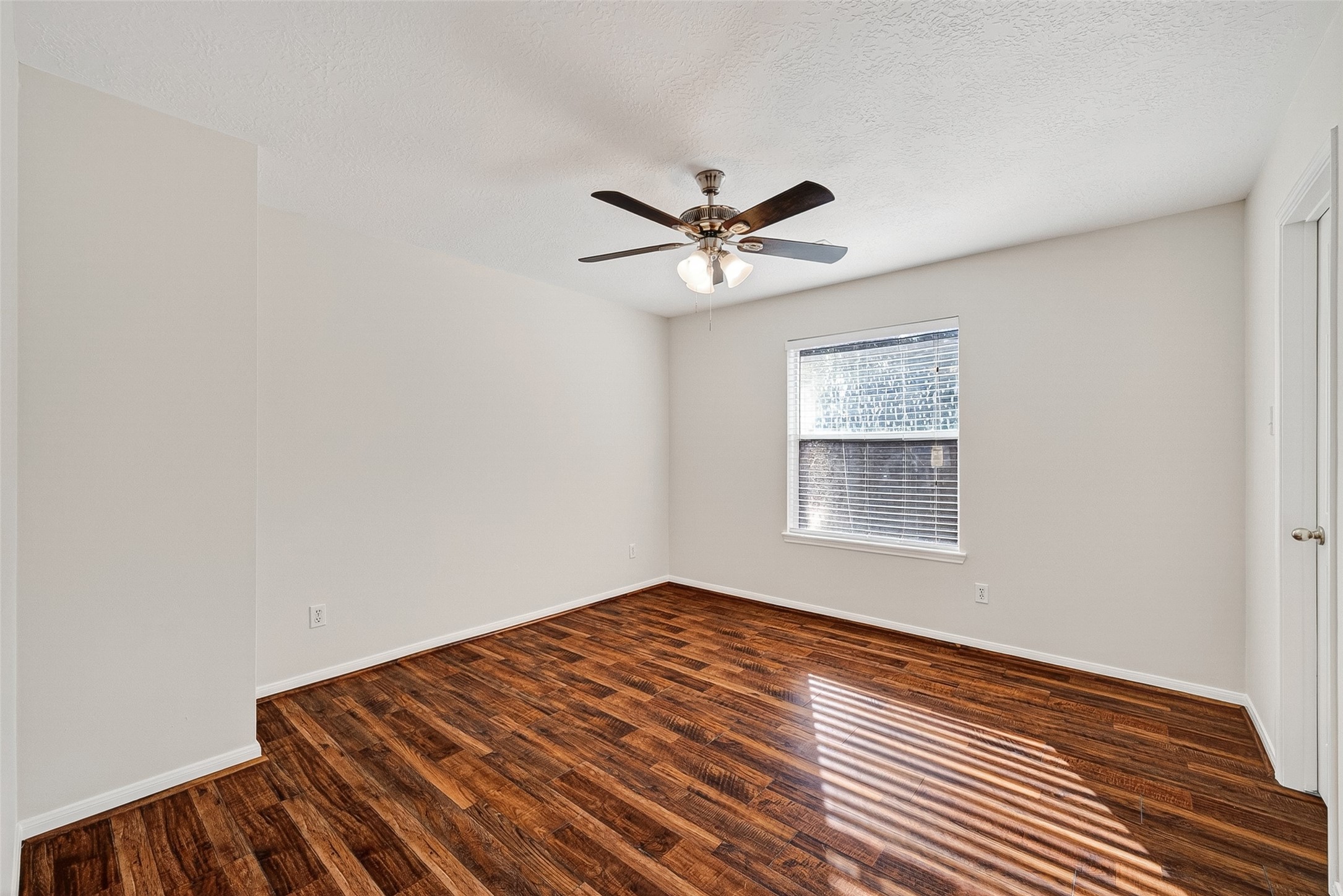 4539 Springfield Lakes Street Sugar Land, TX 77479 - Photo 28 of 34 a view of an empty room with a window and a chandelier fan