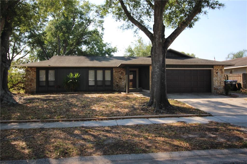 4761 Deer Road Orlando, FL 32812 - Photo 1 of 1 a front view of a house with garden
