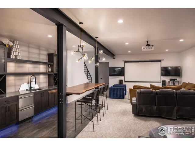 a living room with furniture a flat screen tv and a wooden floor