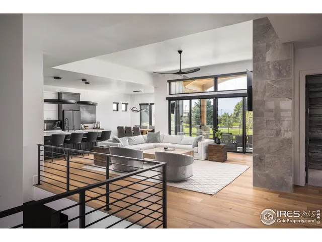 a living room with furniture a large window and appliances