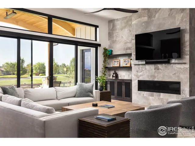 a living room with fireplace furniture and a flat screen tv