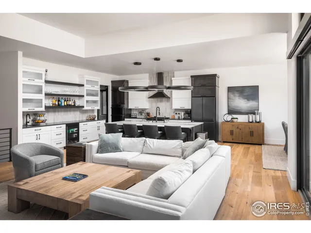 a living room with furniture kitchen view and a fireplace