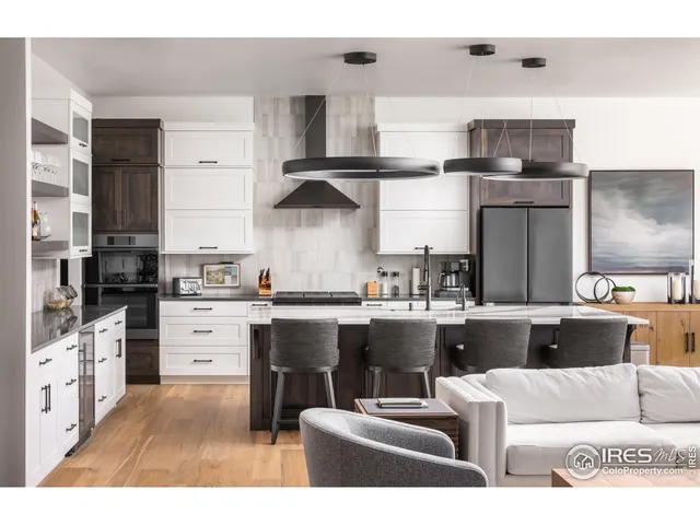 a kitchen with kitchen island stainless steel appliances a stove refrigerator and cabinets