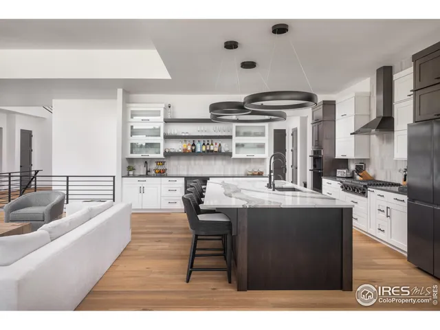 a open kitchen with stainless steel appliances granite countertop a stove and a refrigerator