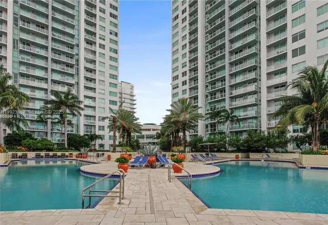 a view of swimming pool with outdoor seating and plants