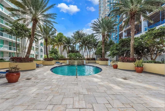 a swimming pool with outdoor seating