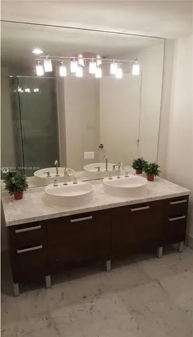 a bathroom with a sink double vanity and a mirror