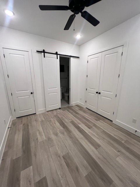 8508 Wileyvale Road, Unit B Houston, TX 77016 - Photo 8 of 16 an empty room with wooden floor ceiling fan and windows