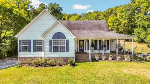 an aerial view of a tennis ground and a swimming pool