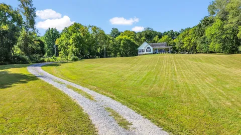 a view of a house with backyard porch and sitting area
