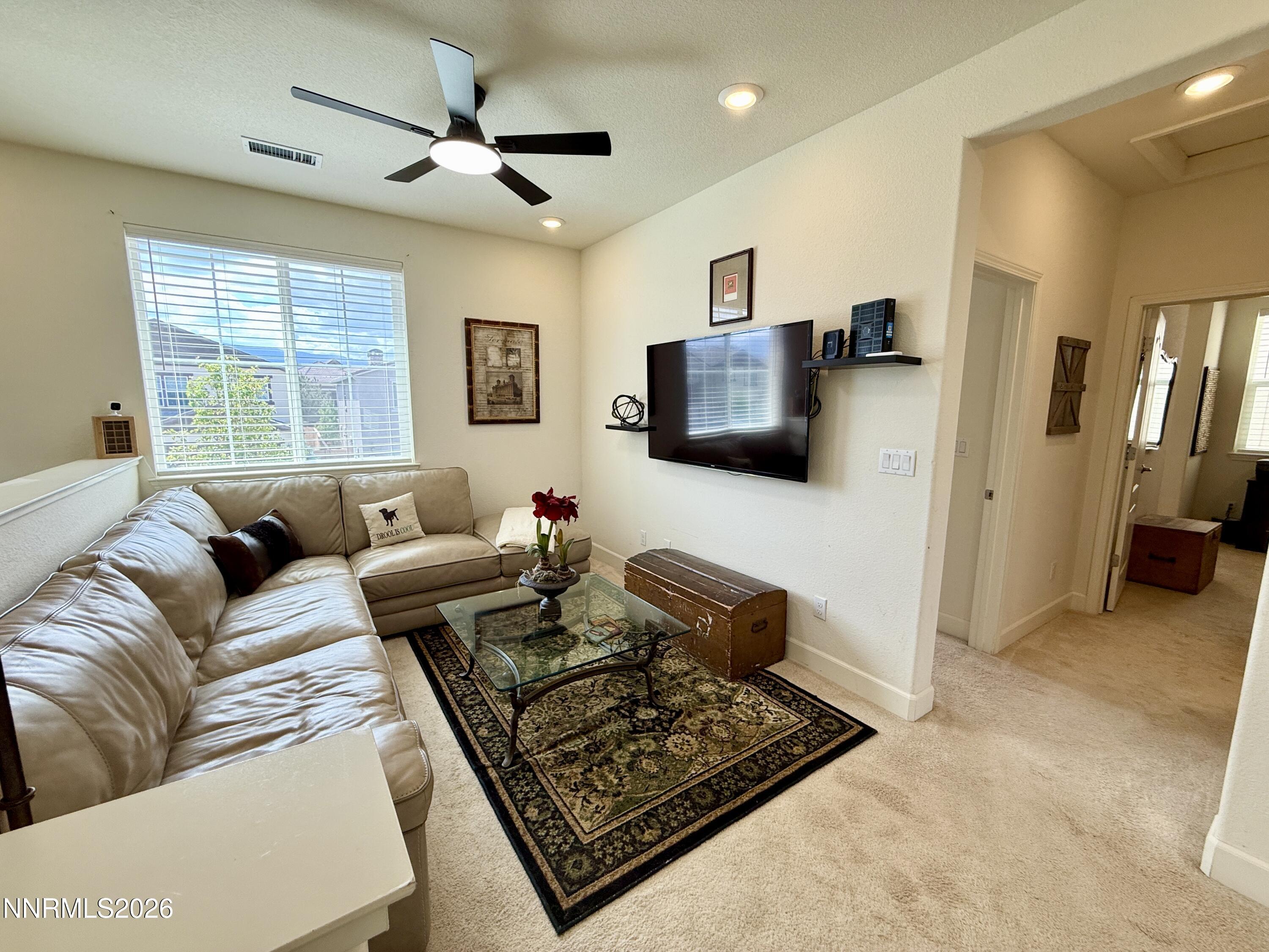 9766 Pachuca Drive Reno, NV 89521 - Photo 21 of 59 a living room with furniture and a flat screen tv