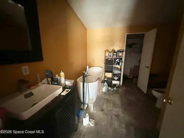 a bathroom with a sink toilet and a mirror