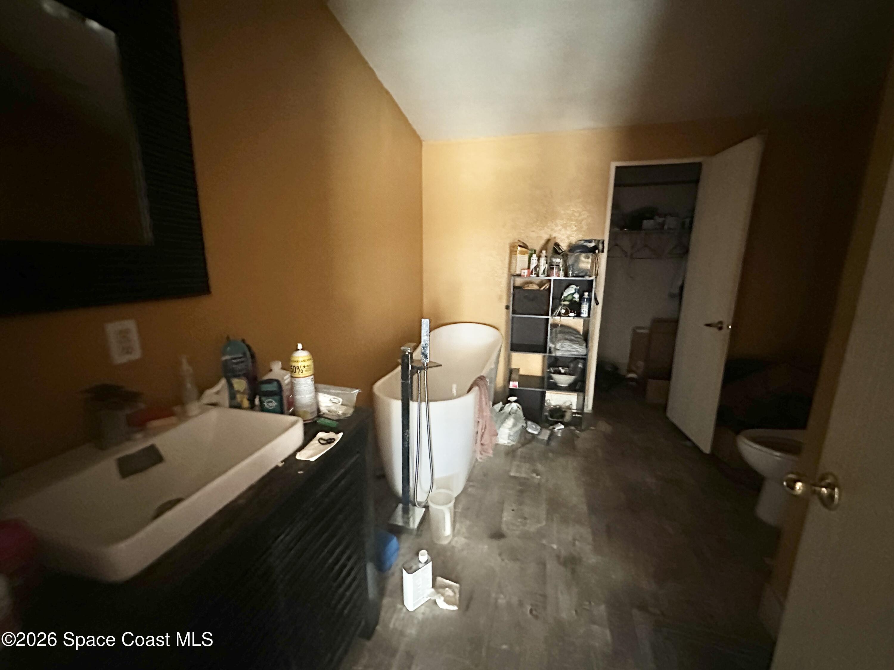 3550 Arbor Avenue Bunnell, FL 32110 - Photo 11 of 21 a bathroom with a sink toilet and a mirror