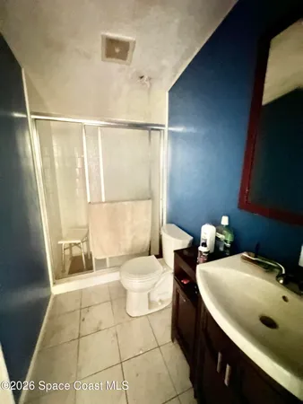 a bathroom with a sink mirror vanity and toilet