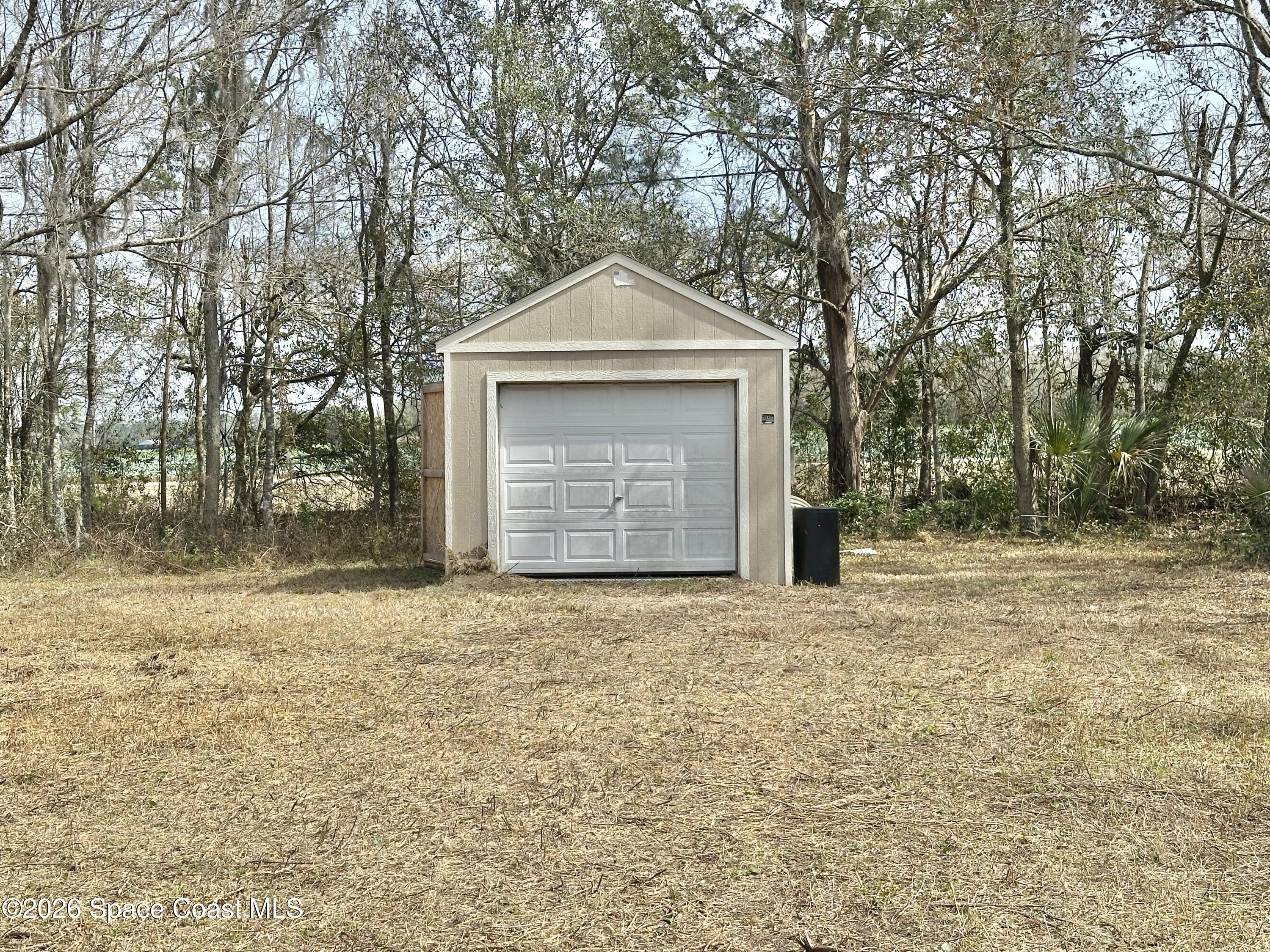 3550 Arbor Avenue Bunnell, FL 32110 - Photo 19 of 21 a front view of a house with a yard and garage