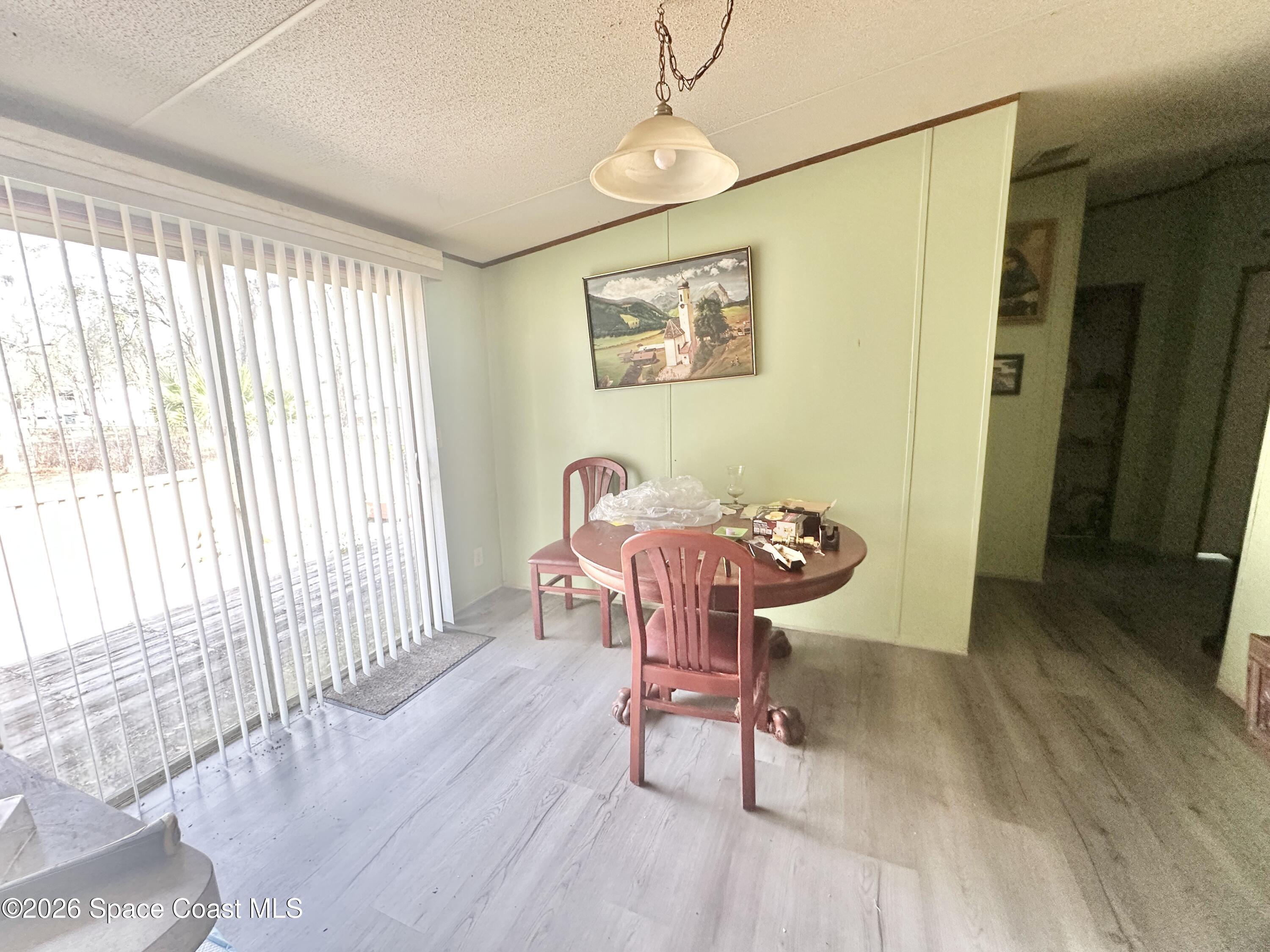 3550 Arbor Avenue Bunnell, FL 32110 - Photo 7 of 21 a dining room with wooden floor and a chandelier