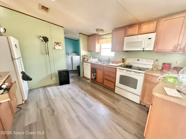 a kitchen with a sink appliances and cabinets