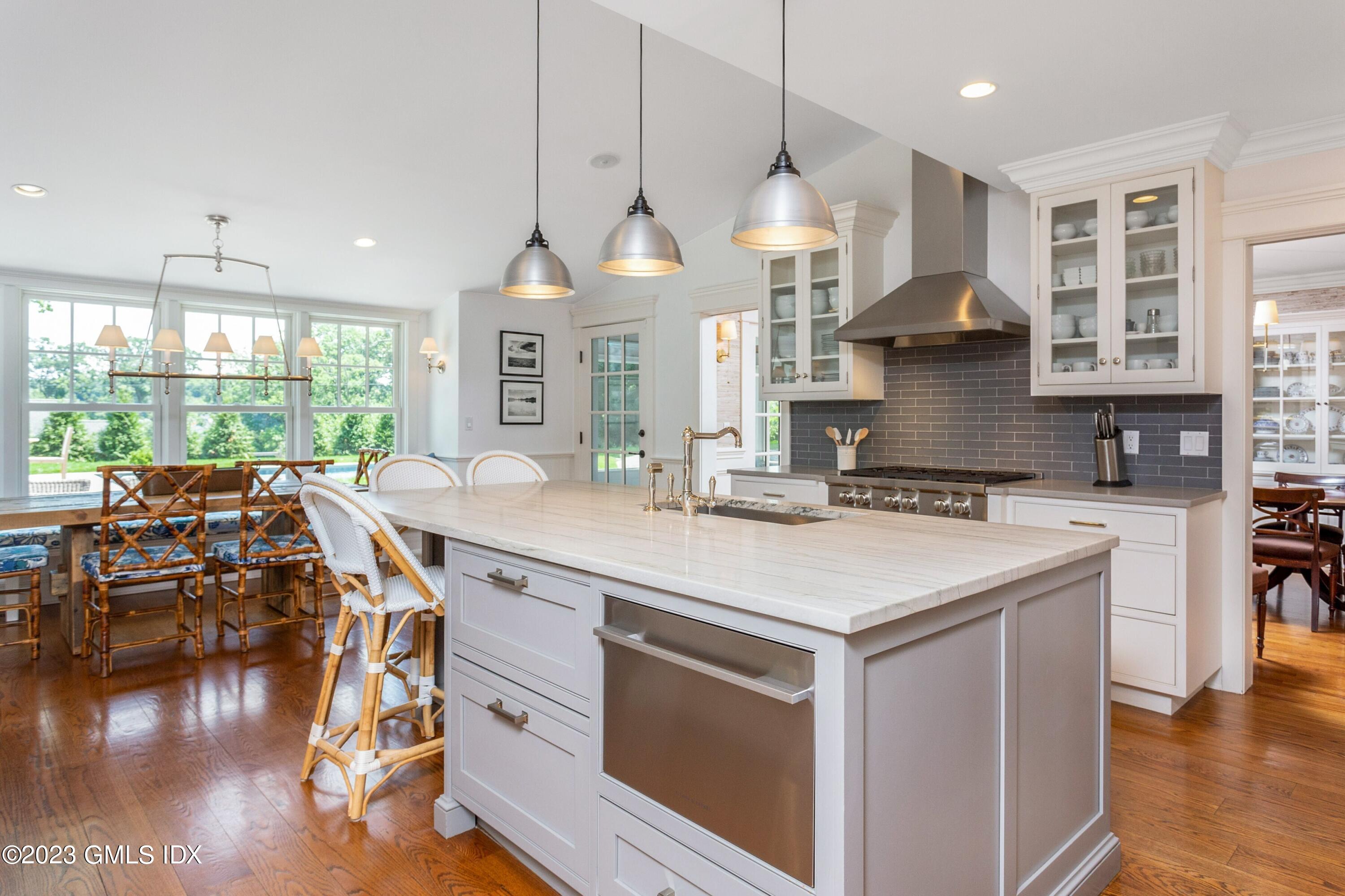 150 Goodwives River Road Darien, CT 06820 - Photo 11 of 39 a kitchen with a stove a counter space a large window and furniture