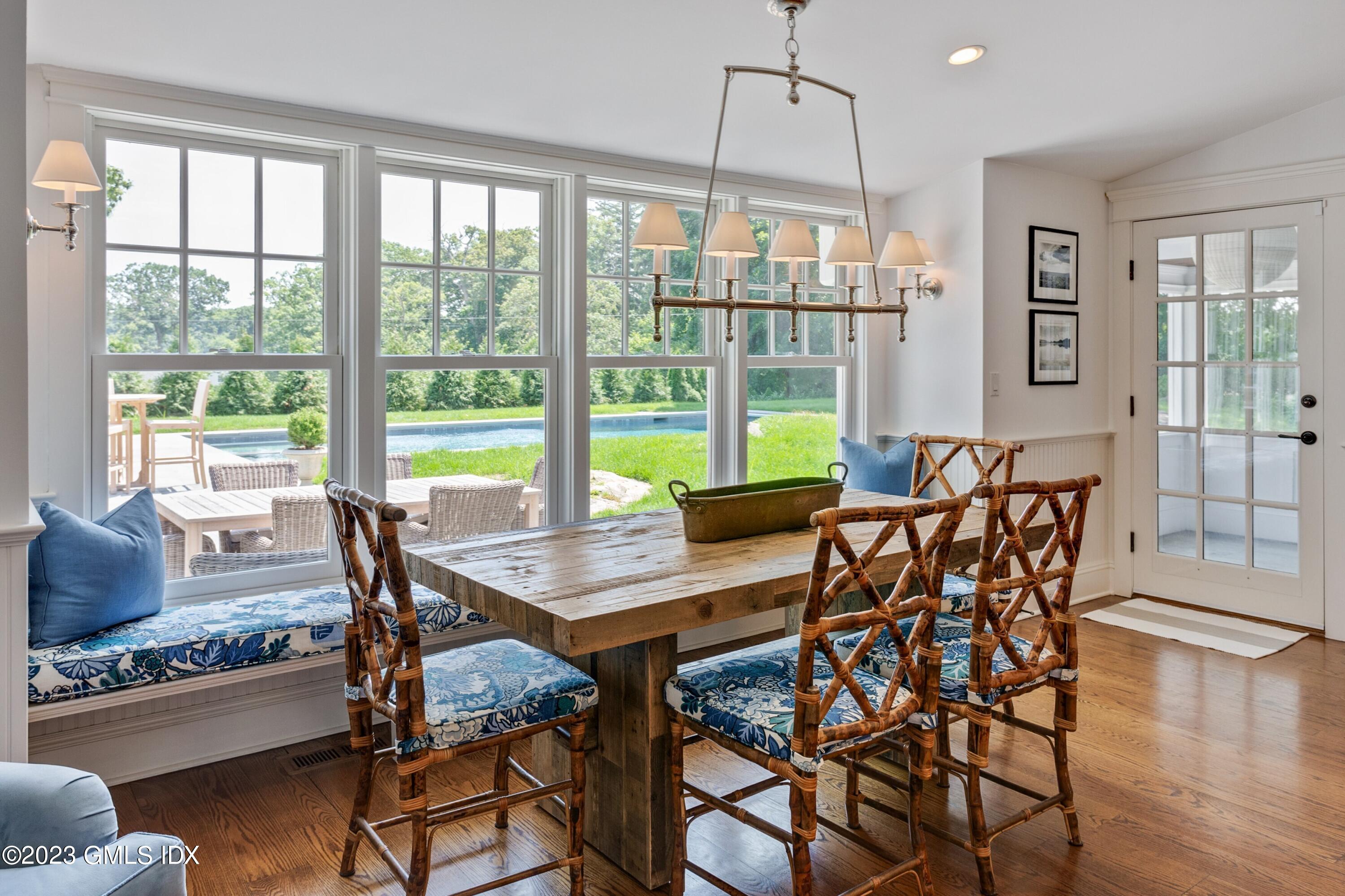 150 Goodwives River Road Darien, CT 06820 - Photo 12 of 39 a view of a dining room with furniture window and wooden floor