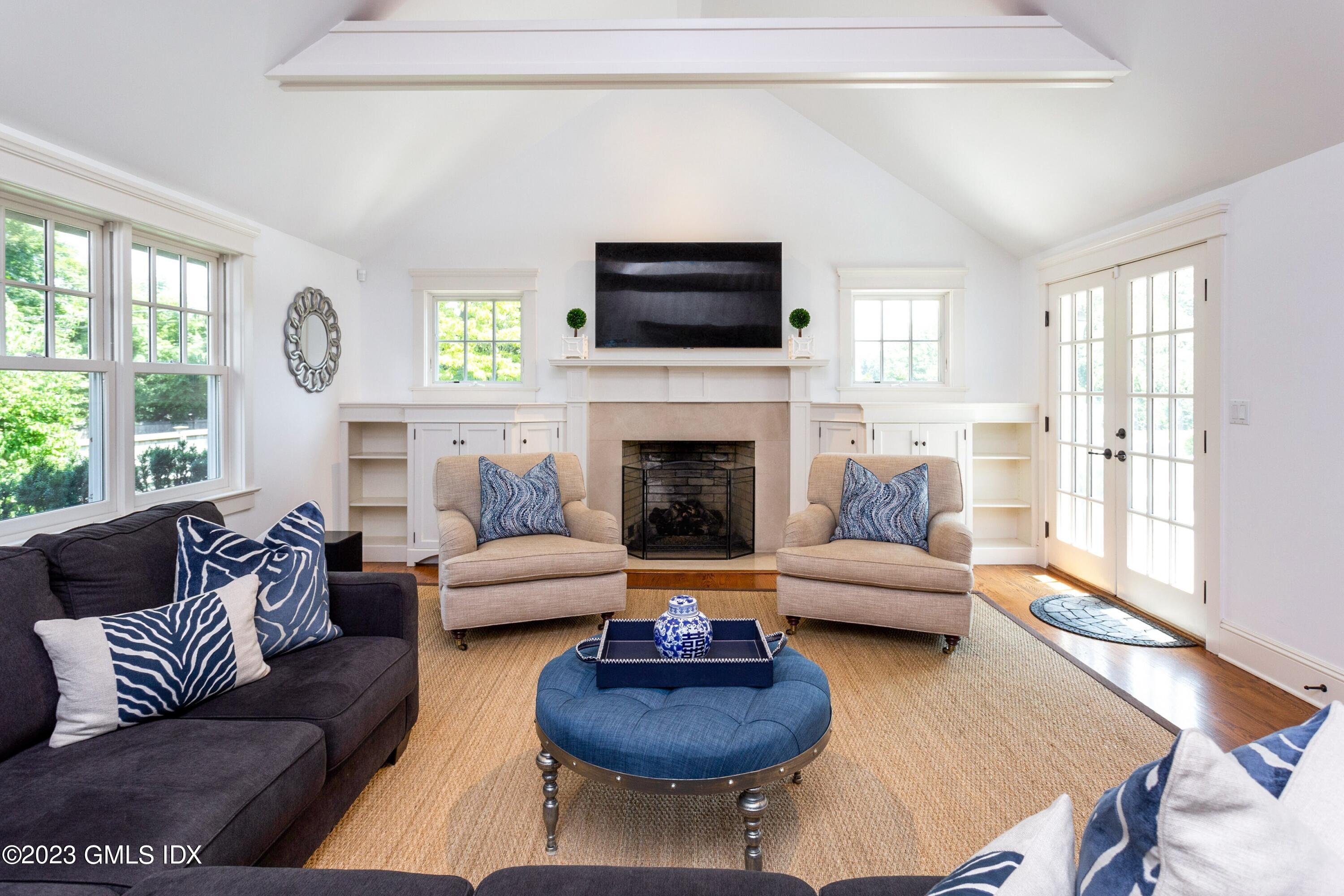 150 Goodwives River Road Darien, CT 06820 - Photo 13 of 39 a living room with furniture a flat screen tv and a fireplace