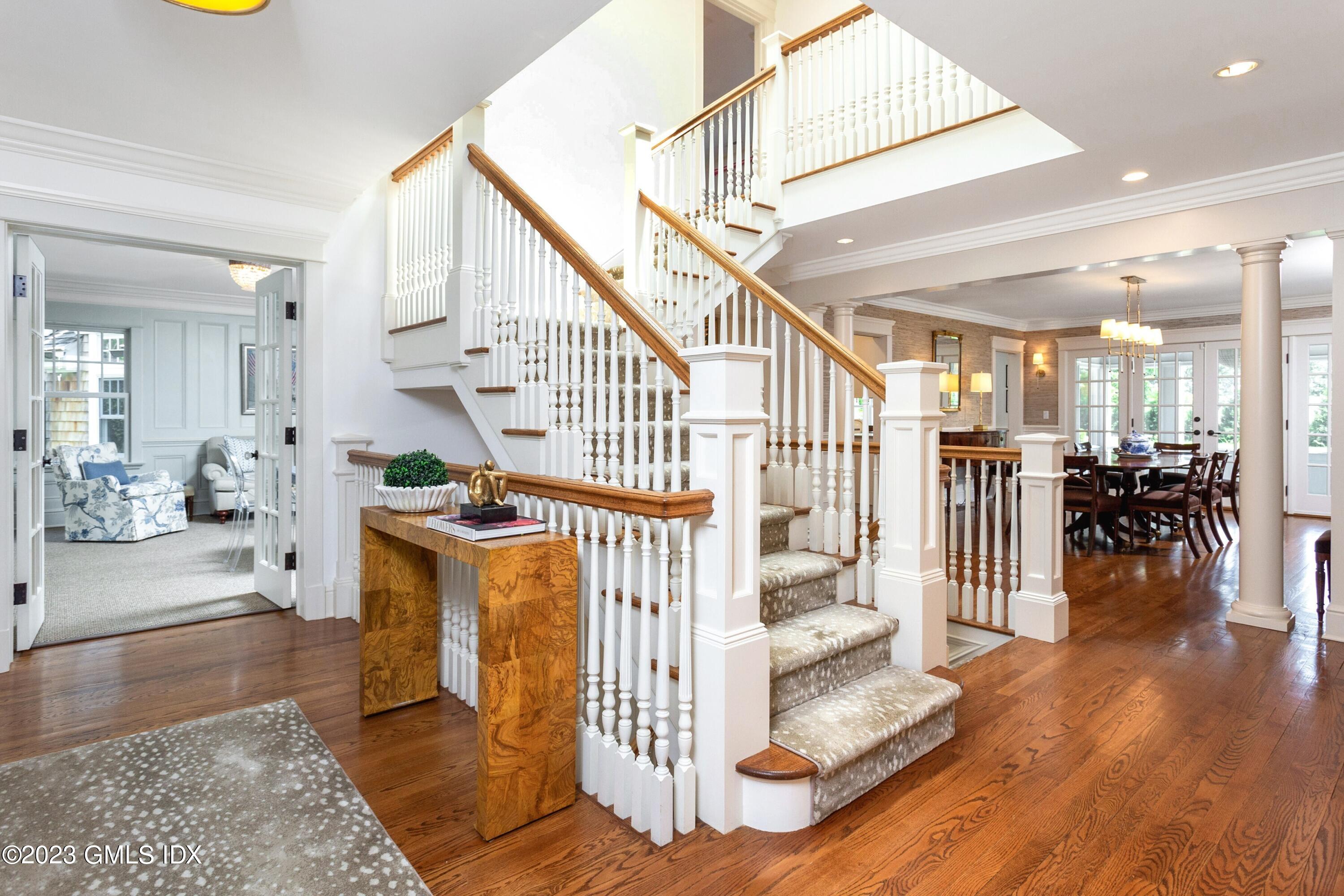 150 Goodwives River Road Darien, CT 06820 - Photo 17 of 39 a view of entryway dining room and hall with wooden floor