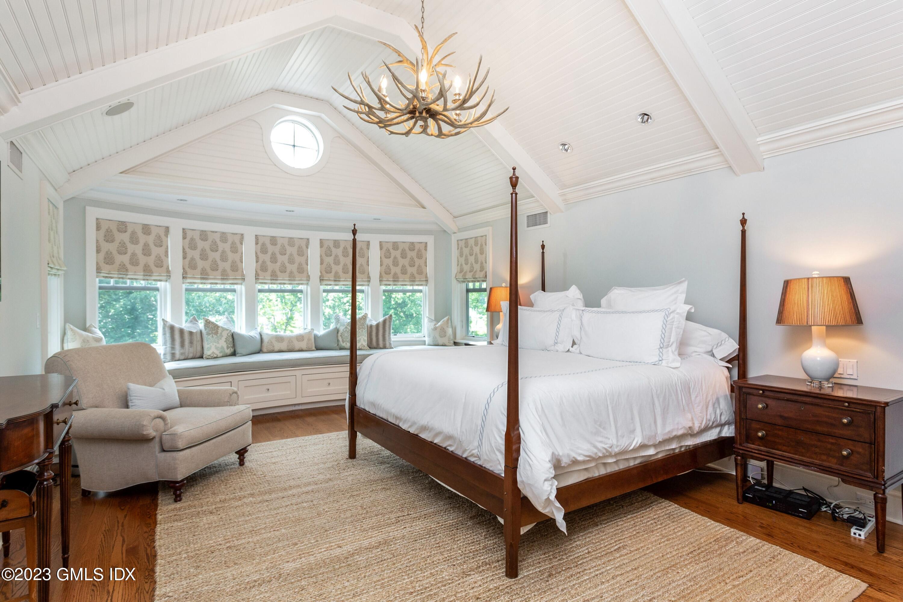 150 Goodwives River Road Darien, CT 06820 - Photo 18 of 39 a bedroom with a bed and wooden floor